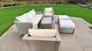 Outdoor patio furniture set with beige cushions on a stone patio