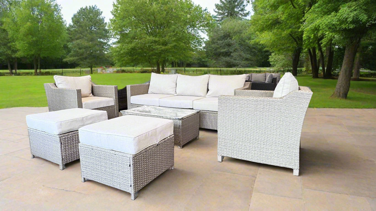 Outdoor furniture set in a showroom with 'Sun West' sign in the background